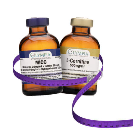 Two amber-colored vials labeled "MICC" and "L-Carnitine 500mg/ml" from Olympia Compounding Pharmacy, wrapped with a coiled purple measuring tape.